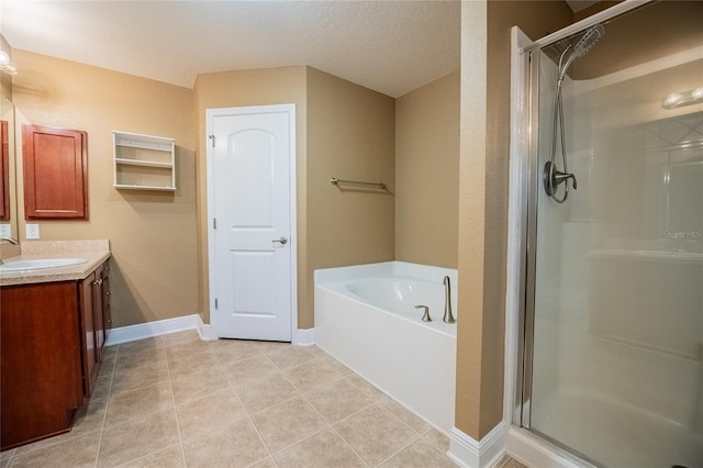 2933 Blackwater Oaks Dr, Mulberry, FL 33860 - full bathroom featuring vanity, a shower stall, a garden tub, and tile patterned flooring