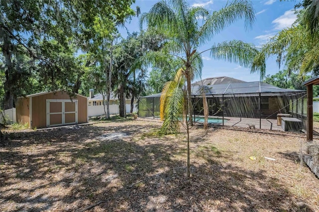 2933 Blackwater Oaks Dr, Mulberry, FL 33860 - view of yard featuring a fenced in pool, a shed, glass enclosure, an outbuilding, and central air condition unit