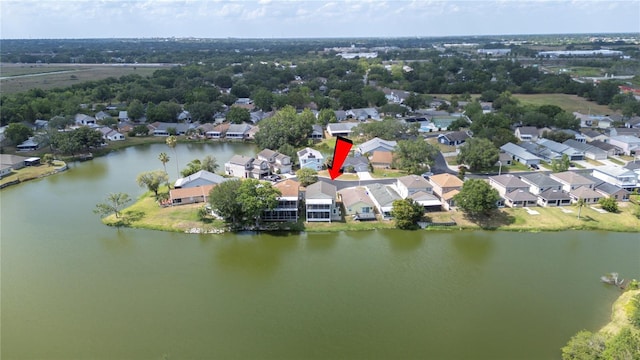 drone / aerial view with a water view and a residential view