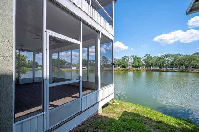 view of side of home with a water view and a sunroom