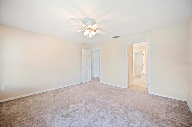 unfurnished bedroom featuring visible vents, baseboards, ceiling fan, connected bathroom, and carpet