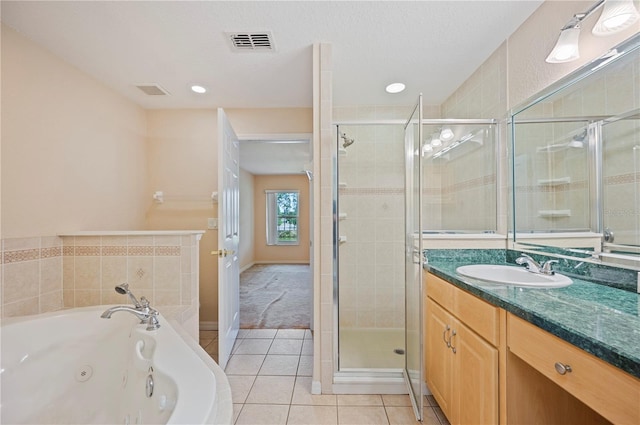 full bath featuring a jetted tub, visible vents, tile patterned flooring, a shower stall, and vanity