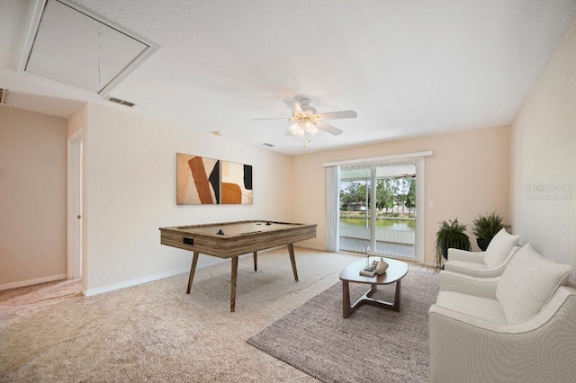 rec room with ceiling fan, attic access, carpet flooring, and visible vents