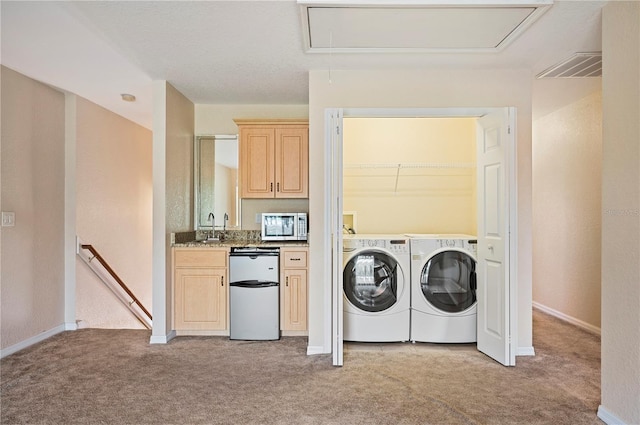 washroom with laundry area, attic access, washer and dryer, and light carpet