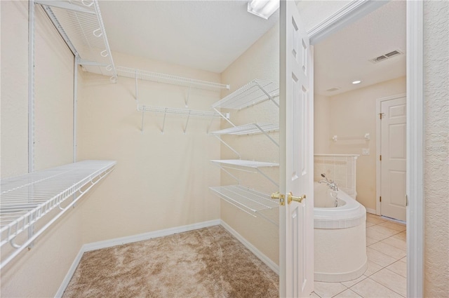 spacious closet featuring visible vents