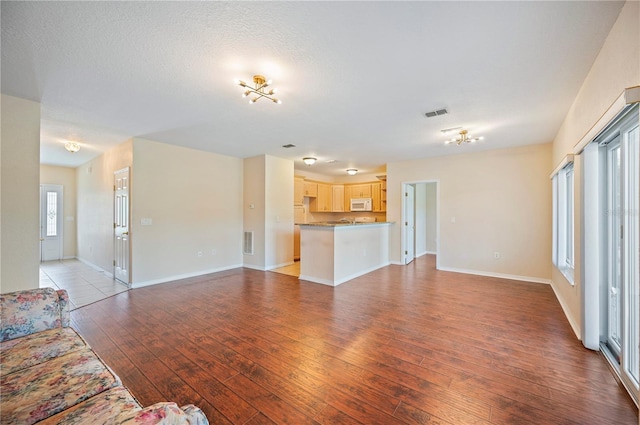 2015 Hatteras Pt, Lakeland, FL 33813 - unfurnished living room with light wood-type flooring and baseboards