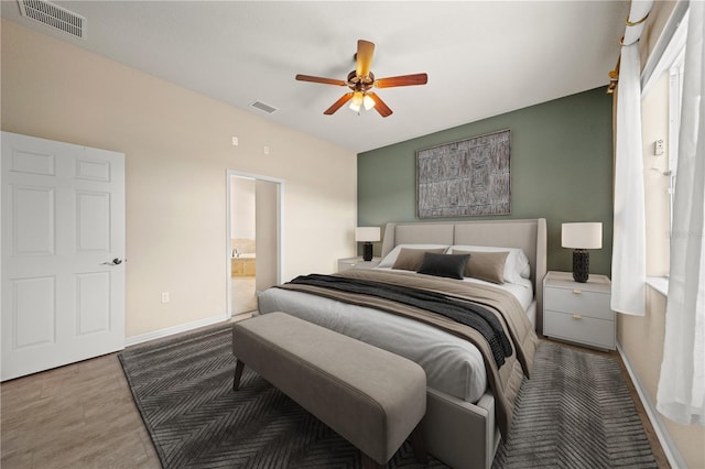 bedroom featuring ceiling fan, visible vents, connected bathroom, and baseboards