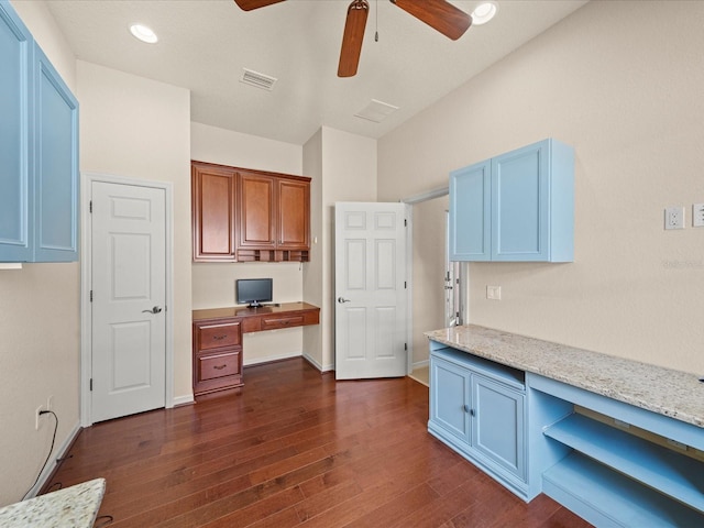 unfurnished office featuring ceiling fan, built in study area, baseboards, visible vents, and dark wood-type flooring