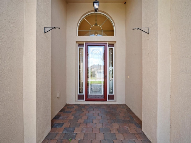 entrance to property with stucco siding