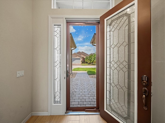 entrance foyer with wood finished floors and baseboards