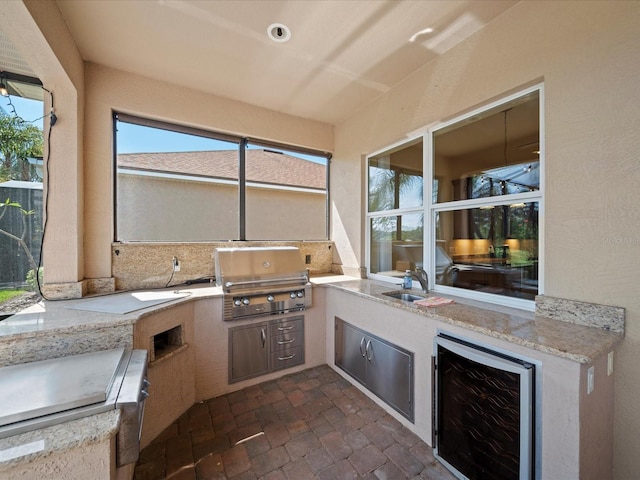 view of patio featuring a sink, area for grilling, and wine cooler
