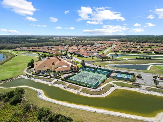birds eye view of property featuring a water view, a residential view, and view of golf course