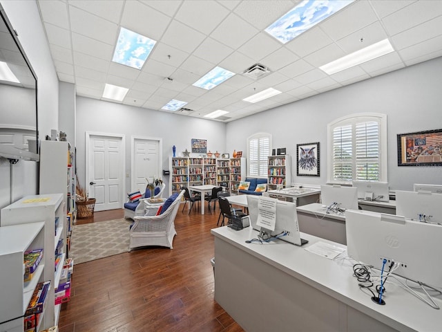 office area featuring a paneled ceiling, dark wood-style flooring, and visible vents