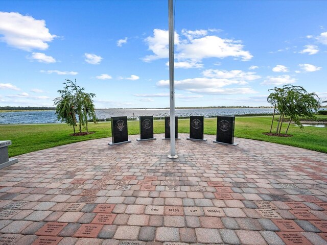 exterior space with a lawn and a water view