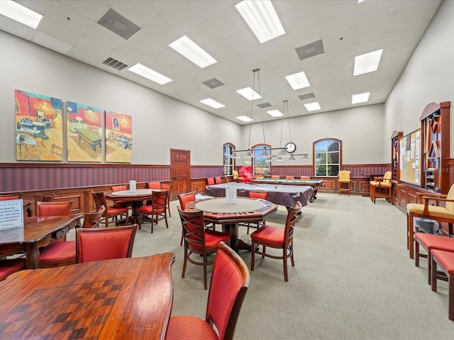 playroom with a high ceiling, a paneled ceiling, visible vents, wainscoting, and carpet floors