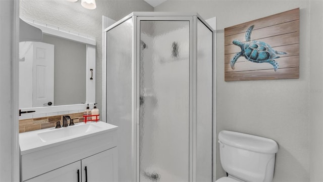 bathroom featuring vanity, decorative backsplash, a textured wall, toilet, and a shower stall