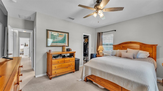 bedroom featuring visible vents, light carpet, a spacious closet, and a closet