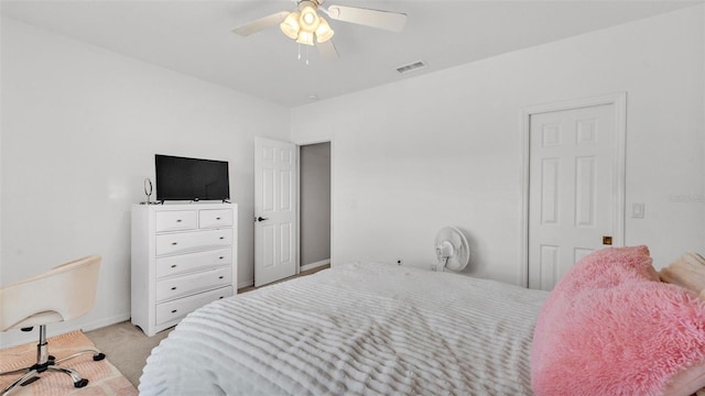 bedroom featuring visible vents, a ceiling fan, baseboards, and light colored carpet