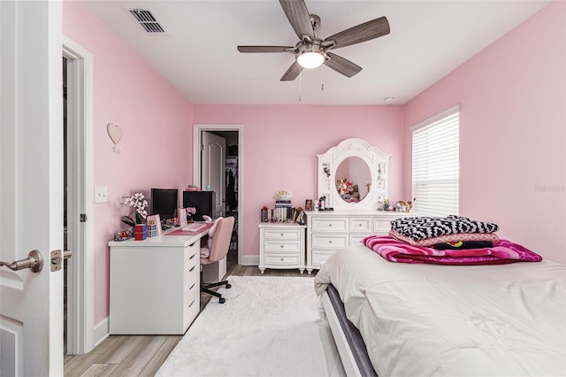 bedroom featuring baseboards, ceiling fan, light wood finished floors, and visible vents