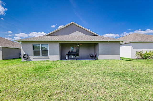 back of house with a patio, ceiling fan, a yard, and stucco siding