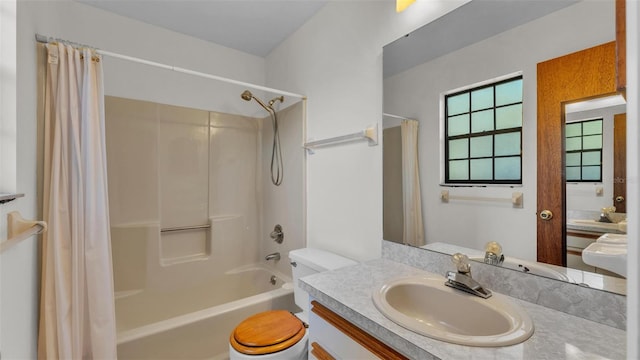 full bath with vanity, shower / tub combo with curtain, and toilet