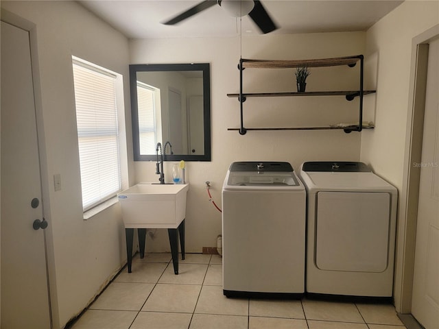 laundry area featuring laundry area, a ceiling fan, a sink, light tile patterned flooring, and washer and clothes dryer