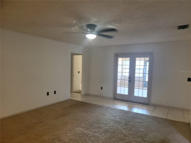 spare room with baseboards, ceiling fan, light colored carpet, french doors, and light tile patterned floors