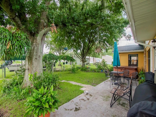 427 Longfellow Blvd, Lakeland, FL 33801 - view of yard featuring a patio, fence, and outdoor dining space