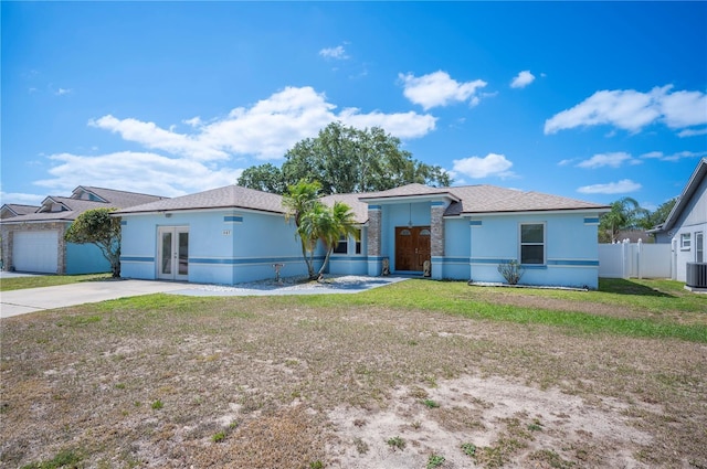 603 Reflections Loop, Winter Haven, FL 33884 - ranch-style house with french doors, central AC unit, stucco siding, and driveway