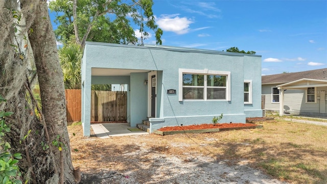 view of front of property featuring fence and stucco siding
