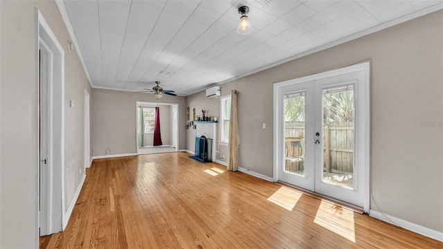 unfurnished living room with french doors, a wealth of natural light, and light wood-style flooring