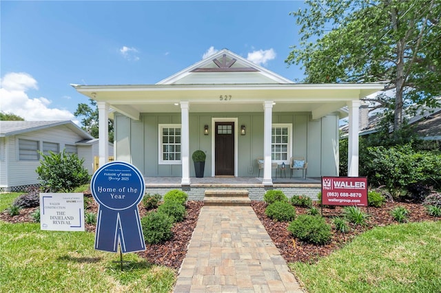 527 W Park St, Lakeland, FL 33803 - view of front of house with board and batten siding and covered porch