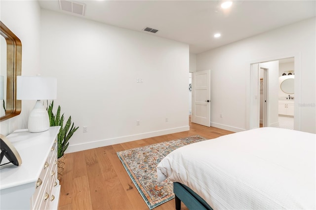 527 W Park St, Lakeland, FL 33803 - bedroom with light wood-style floors, recessed lighting, ensuite bath, baseboards, and a sink