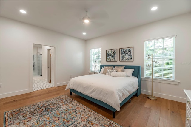527 W Park St, Lakeland, FL 33803 - bedroom with baseboards, light wood-style flooring, recessed lighting, ceiling fan, and connected bathroom