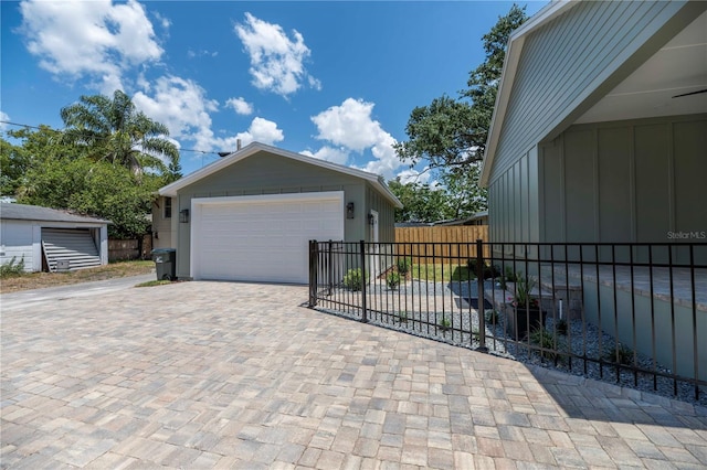 527 W Park St, Lakeland, FL 33803 - view of property exterior with board and batten siding and a detached garage