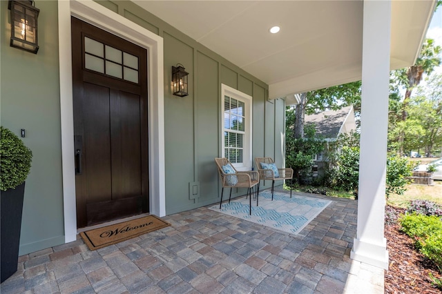 527 W Park St, Lakeland, FL 33803 - view of exterior entry featuring a porch and board and batten siding