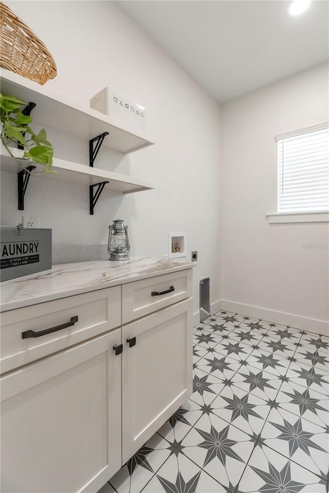 527 W Park St, Lakeland, FL 33803 - laundry area featuring electric dryer hookup, baseboards, light floors, washer hookup, and cabinet space