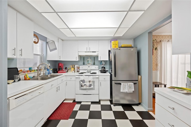 kitchen with white appliances, white cabinetry, under cabinet range hood, tile patterned floors, and a sink