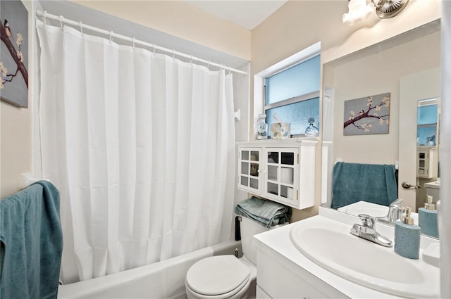 bathroom featuring vanity, shower / bath combo, and toilet