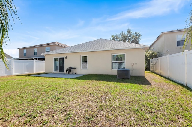 rear view of property featuring a fenced backyard, a patio area, stucco siding, and central AC unit