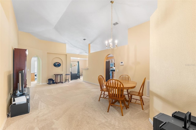 dining space featuring visible vents, arched walkways, baseboards, and light carpet