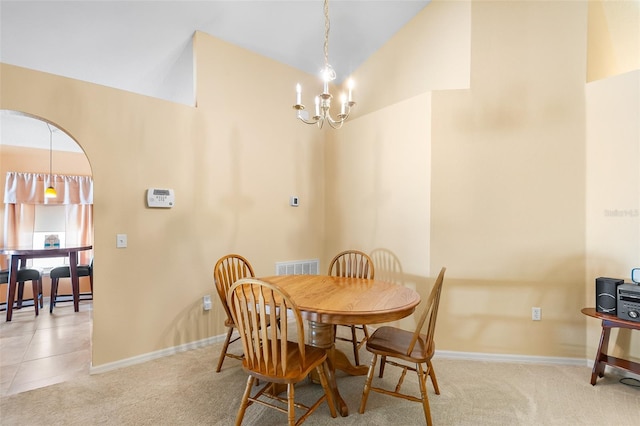 dining space with visible vents, baseboards, carpet, and lofted ceiling