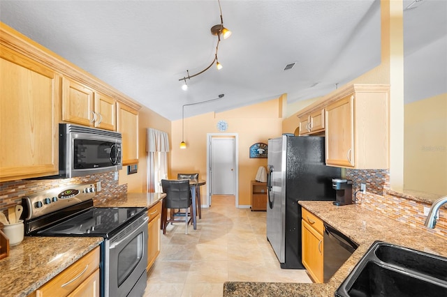 kitchen featuring visible vents, vaulted ceiling, a sink, light brown cabinets, and stainless steel appliances
