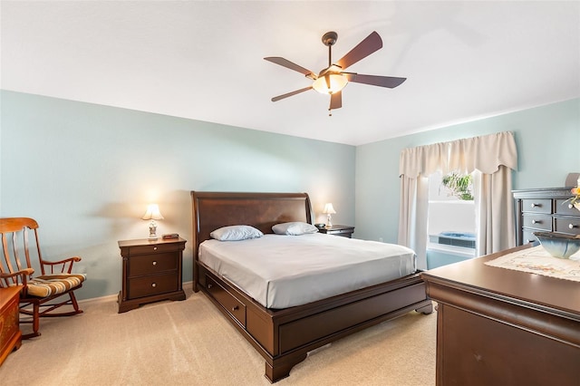 bedroom with baseboards, a ceiling fan, and light colored carpet