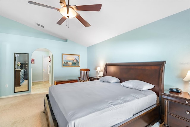 bedroom with ceiling fan, light colored carpet, arched walkways, lofted ceiling, and visible vents