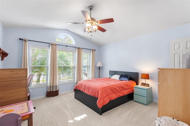 carpeted bedroom featuring baseboards, ceiling fan, vaulted ceiling, and multiple windows