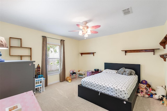 bedroom featuring carpet floors, a ceiling fan, baseboards, and visible vents