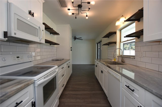 kitchen featuring visible vents, open shelves, a sink, and white appliances