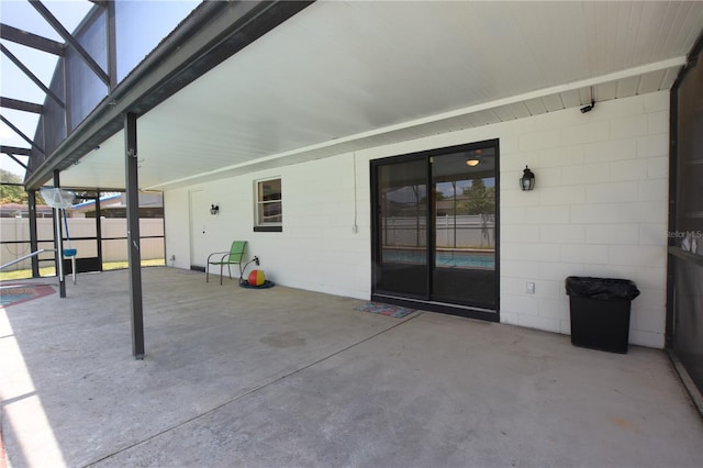 view of patio with a lanai and fence