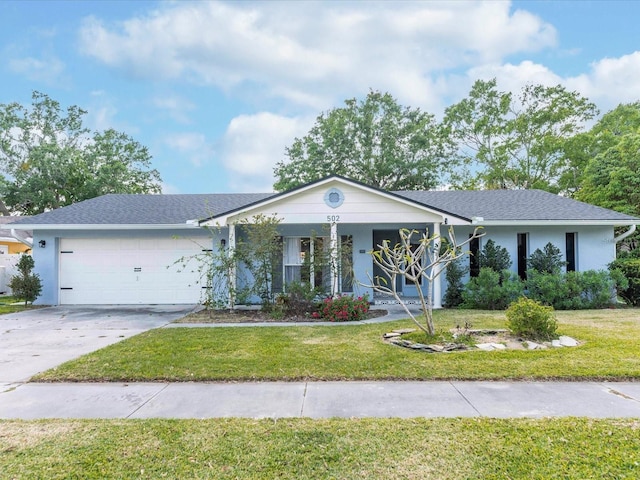 502 Duchess Dr, Lakeland, FL 33803 - ranch-style house featuring an attached garage, a front lawn, covered porch, and concrete driveway